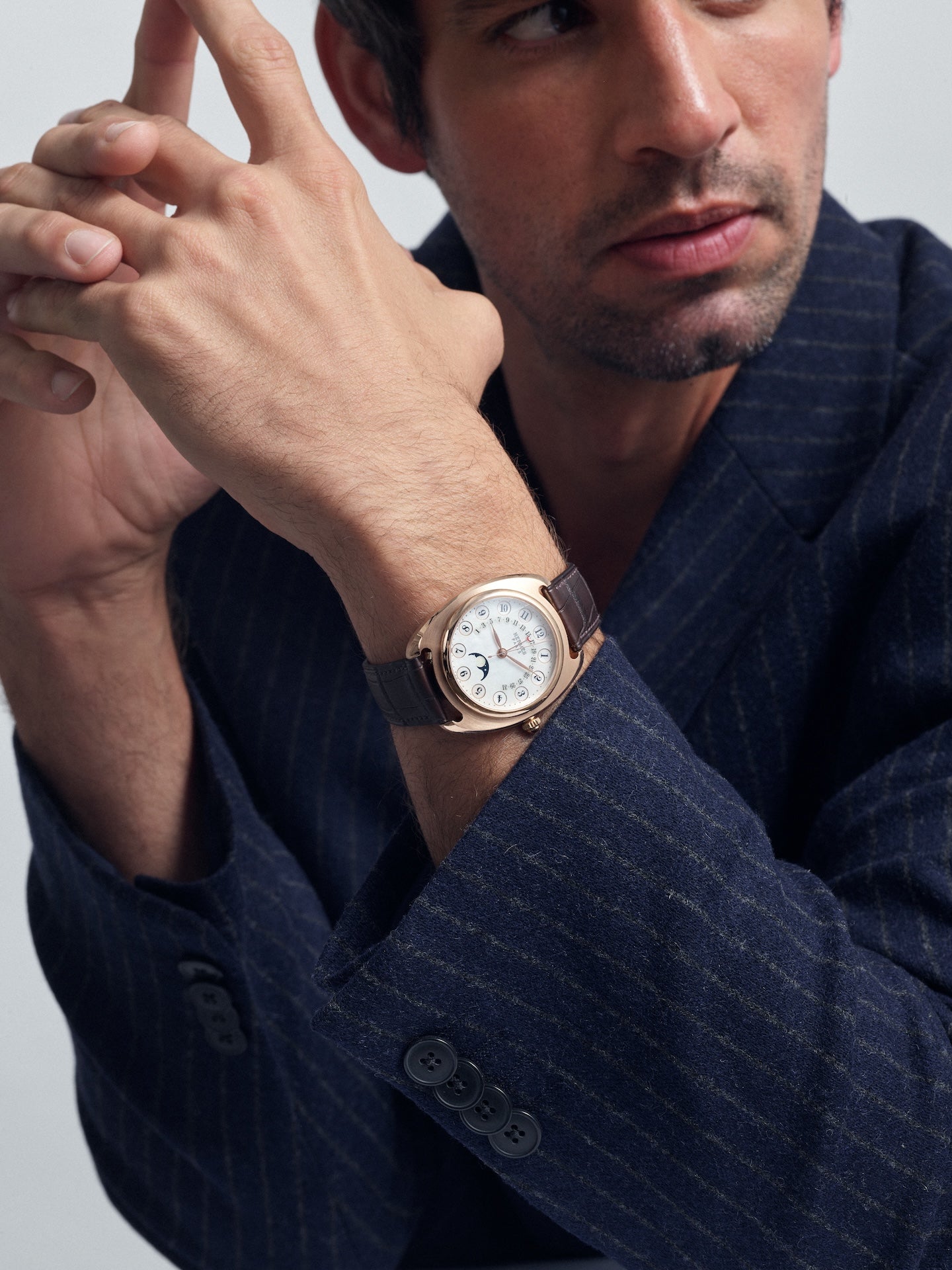Man wearing watch and suit