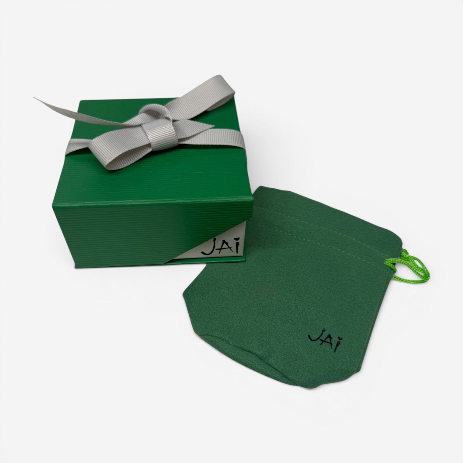 THE SOLIST green gift box with grey ribbon and matching branded pouch for JAI jewelry packaging