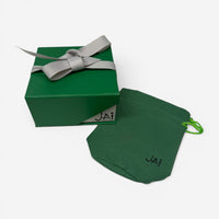 THE SOLIST green gift box with grey ribbon and matching branded pouch for JAI jewelry packaging