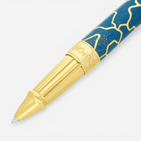 THE SOLIST S.T. Dupont x Fender blue and gold rollerball pen with intricate pattern and gold accents.