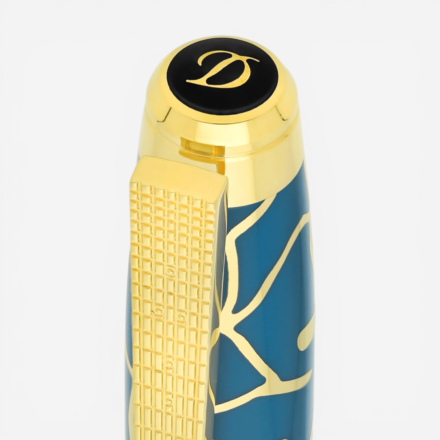 THE SOLIST S.T. Dupont x Fender blue and gold brass rollerball pen with intricate pattern and gold accents.